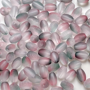 Macro view of frosted gradient glass beads in pink and green for DIY jewelry making