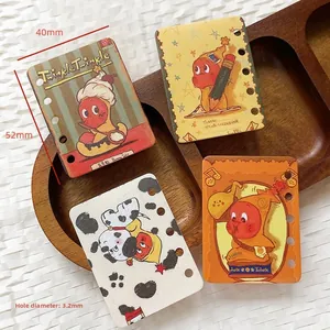 Detail view of four colorful mini 6-hole acrylic cards with vintage cartoon character art