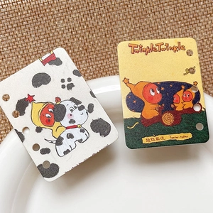 Detail of DIY acrylic loose-leaf cards featuring cartoon cow patterns and star quotes