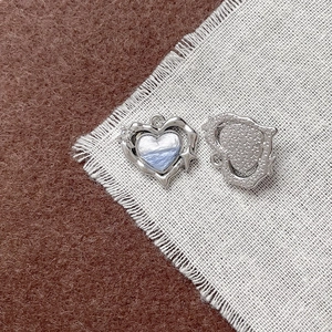 Dettaglio di ciondolo a cuore con motivo nuvola blu e retro con stelle