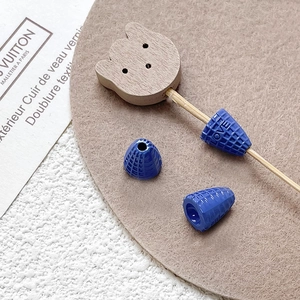 Macro shot of blue conical resin beads with embossed LOVE text for DIY jewelry making