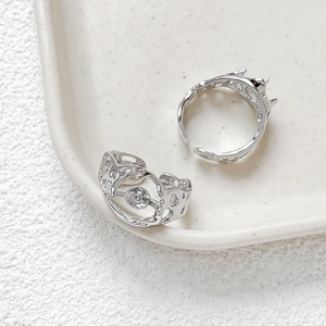 Macro shot of hollow textured 14k gold plated ring base with silver finish and zircon