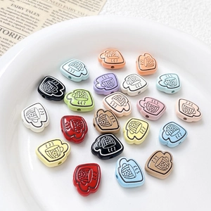 Detailed top view of colorful cartoon teacup beads with flower patterns in a white bowl