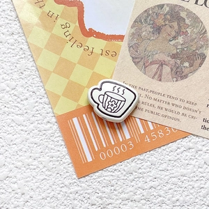 Close-up of a coffee cup charm with floral design for DIY jewelry and crafts