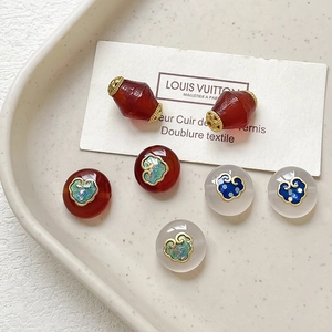 Detailed view of enamel agate beads with auspicious cloud motifs for DIY jewelry