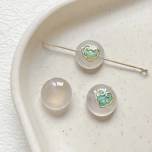 Close-up of natural agate beads with Ruyi enamel patterns for DIY jewelry making