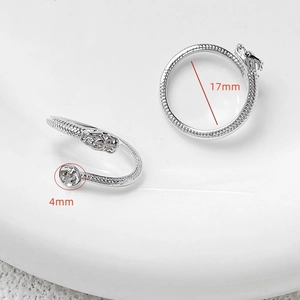 Macro view of 17mm silver dragon scale ring with 4mm bead detail on ceramic tray