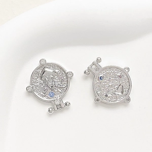 Detailed view of silver-plated coin charms featuring colorful cubic zirconia stones