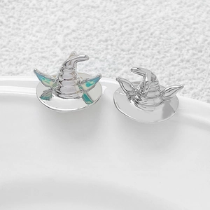 Detail of 14K gold plated wizard hat earrings with blue enamel opal inlay and silver finish