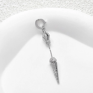 Detailed macro view of silver plated vajra pendant with intricate ethnic engravings