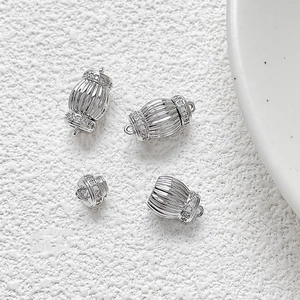 Macro view of silver-plated lantern screw clasps with cubic zirconia for DIY jewelry