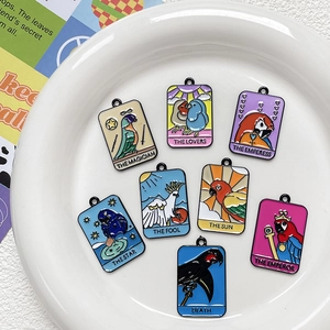 Detailed collection of parrot tarot card charms in colorful enamel on a ceramic plate
