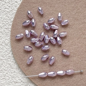 Macro detail of faceted purple glass beads with metallic finish for DIY jewelry making