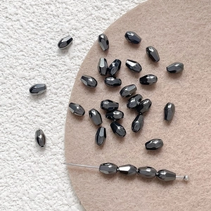 Macro view of metallic black faceted drop beads for DIY jewelry making and handmade crafts