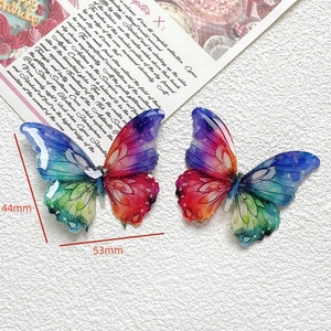 Détail de breloques papillons colorées en résine pailletée, 53mm x 44mm pour bricolage DIY