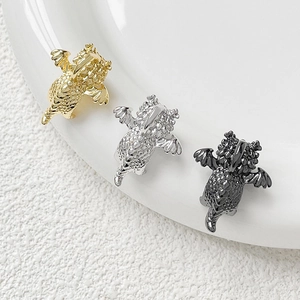 Three gold, silver, and black flying dragon pendants with detailed scales for DIY jewelry