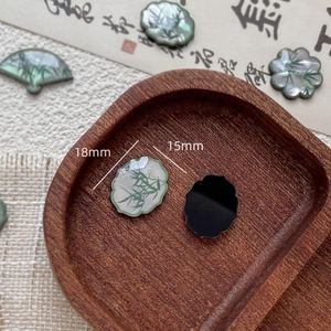 Macro shot of 18mm resin bamboo leaf charms with pearlescent finish and traditional shapes