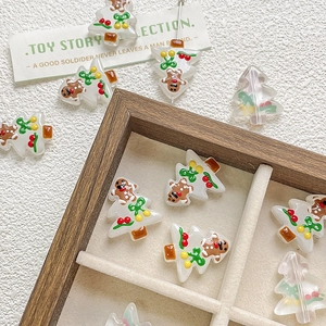 Detail of hand-painted resin Christmas tree beads with gingerbread man on velvet tray