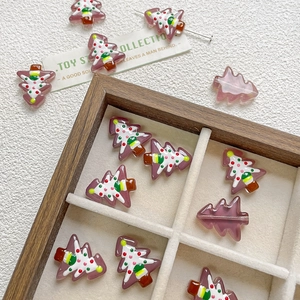 Close-up of hand-painted glass Christmas tree beads for DIY jewelry and phone charms