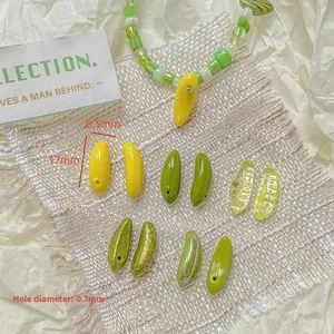 Macro view of mini banana glass beads for DIY jewelry making, 17mm x 6.5mm size