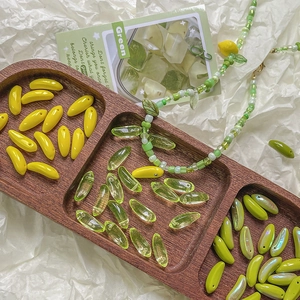 Mini banana glass beads for DIY jewelry making in various green and yellow shades