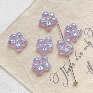 Macro shot of purple flower glass beads with AB coating and center drill hole