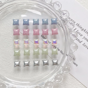 Mix of 25 colorful square resin beads for DIY jewelry and crafts in a glass dish