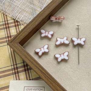 Close-up of Czech butterfly glass beads for DIY jewelry making with metallic trim
