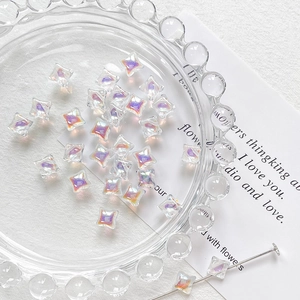 Macro detail of star-shaped iridescent glass beads for DIY jewelry making accessories