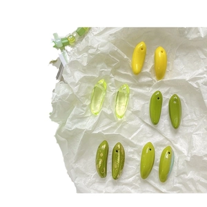 Mini banana glass beads for DIY necklaces and bracelets in various shades of green and yellow