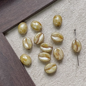 Macro shot of coffee bean shaped loose beads with glazed finish and straight hole design