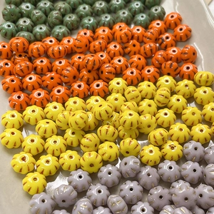 Detailed view of colorful pumpkin-shaped Czech glass beads for DIY jewelry making