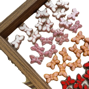 Czech glass butterfly beads in various pink and red tones for DIY jewelry making