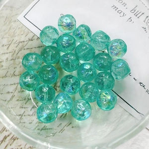 Close-up of mint green iridescent crackle glass beads for DIY jewelry making
