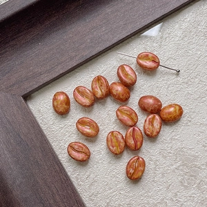 Detail of coffee bean shaped DIY beads with marble texture for jewelry making