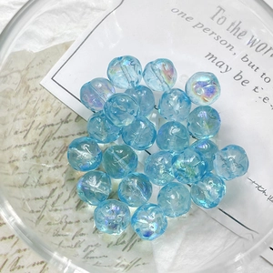 Close-up of light blue aurora Czech glass beads with iridescent coating for DIY jewelry