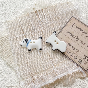 Macro detail of hand-painted dalmatian ceramic beads with two holes for DIY jewelry making
