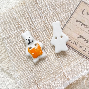 Detail of hand-painted rabbit ceramic button for DIY jewelry with two central holes