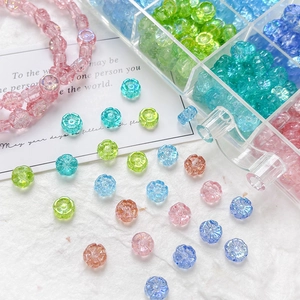 Macro detail of colorful daisy glass beads with organizers for DIY jewelry making