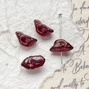 Macro detail of bird-shaped beads with gold etching for DIY jewelry making