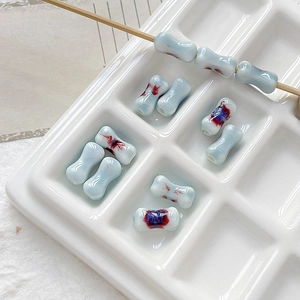 Macro detail of handmade light blue dumbbell ceramic beads with artistic kiln glaze for DIY jewelry
