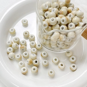 Macro view of round glazed ceramic beads with natural amber texture for DIY jewelry crafts