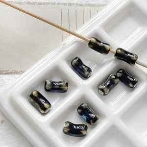 Macro detail of deep blue marble effect ceramic bone beads for DIY jewelry making