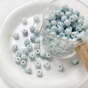 Macro detail of blue and white glazed ceramic beads for DIY jewelry and crafts