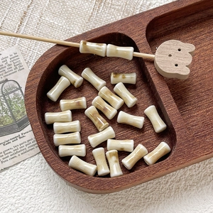 Close-up of hand-painted bamboo joint ceramic beads in vintage style for DIY jewelry making