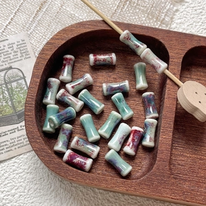 Detailed view of handmade bamboo-shaped ceramic beads with kiln-fired glaze for DIY jewelry