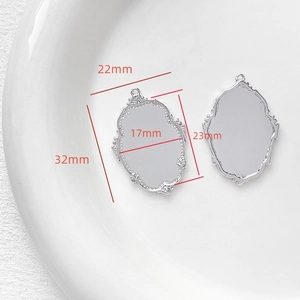 Detailed view of silver baroque oval frame pendants with vintage scroll carvings and dimensions