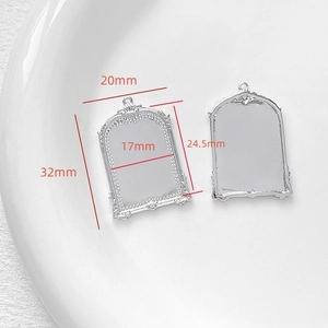 Macro detail of silver baroque frame pendants for DIY jewelry making with dimensions