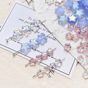Macro view of colorful star glass beads on pins for DIY jewelry making and crafts
