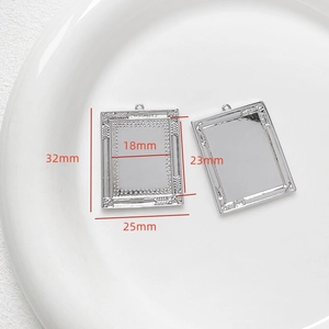 Detailed view of silver-tone Baroque photo frame pendant showing front and back texture